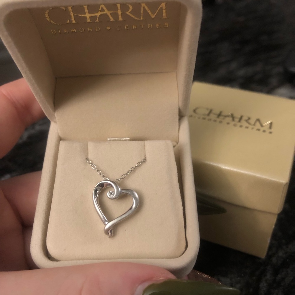 Selling a sterling silver diamond heart pendant with a spring-ring clasp.